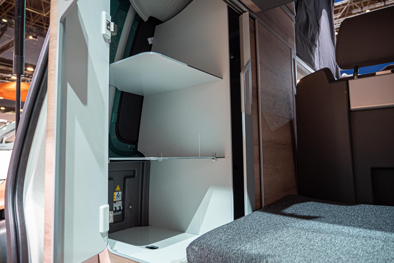 VW California 6.1 – Strand-Hopping mit Stil (inkl. Video-Roomtour) 26 Stauraum Regal innen in einem VW California 6.1 auf dem Messestand des Caravan Salon 2019 in Düsseldorf
